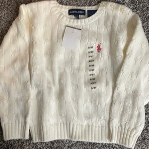Girls sweater small stain above polo horse
